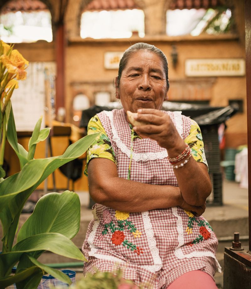 Elderly woman sharing a story over a meal
